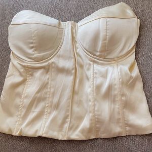 Women’s cream corset style top. 100% polyester.